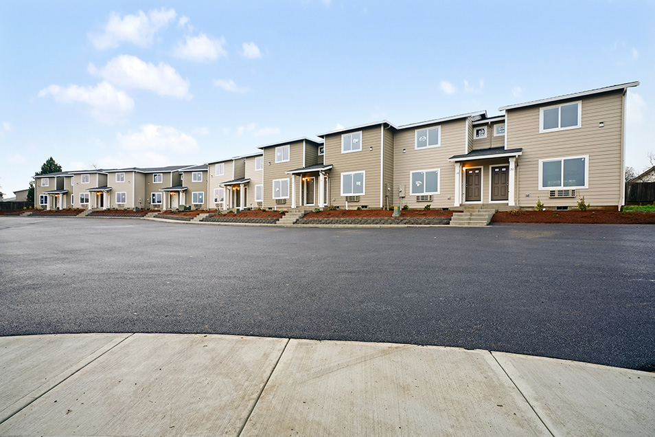 An image of a townhome complex with tan siding